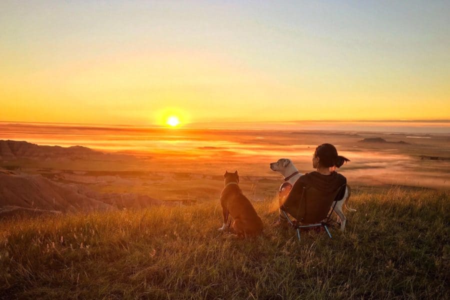 Woman with two dogs overlooking Pawnee National Grassland in Colorado